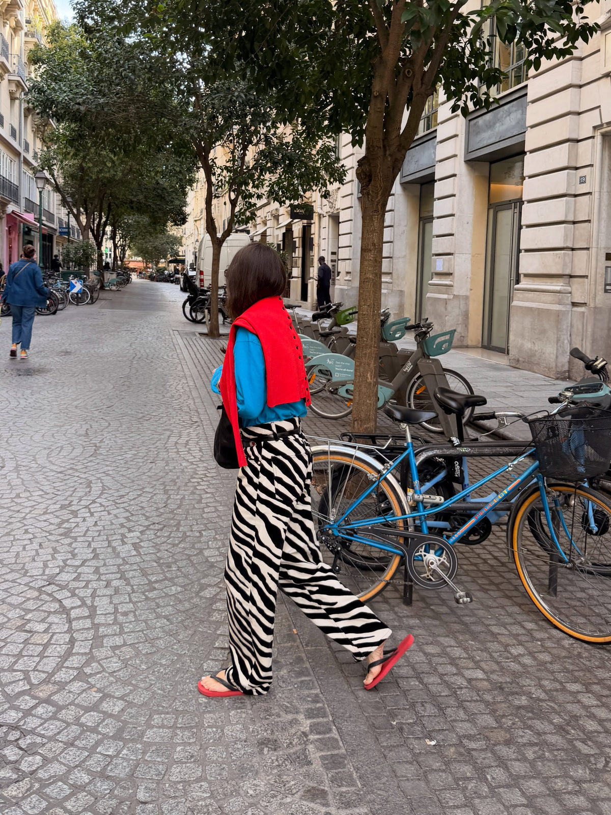 Rear side view of black-and-cream zebra print relaxed trousers